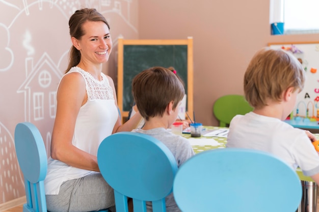 Happy teacher watching kids