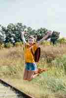 Free photo happy teen girl jumping on the railway