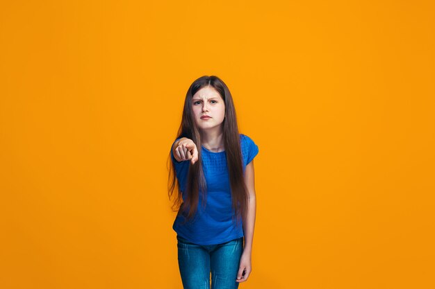 The happy teen girl pointing to you, half length closeup portrait