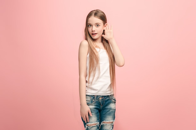 Free photo the happy teen girl standing and listening on trendy pink studio