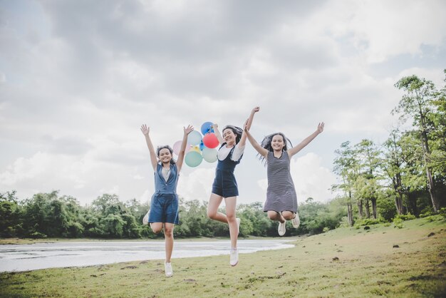 Happy teenage friends smiling outdoors at the park