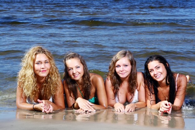 Free photo happy teenagers playing at the sea