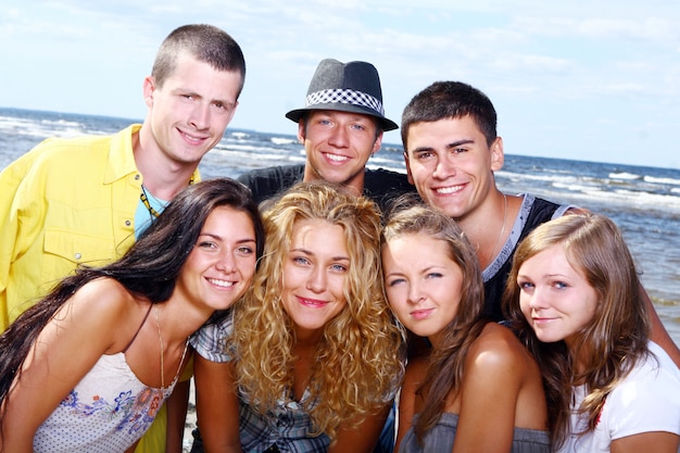 Happy teenagers playing at the sea