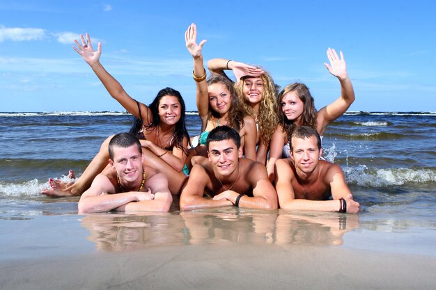 Happy teenagers playing at the sea