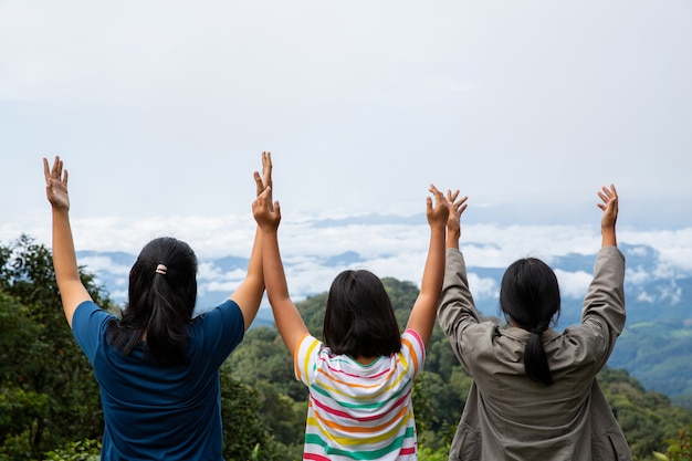 Free photo happy teens deep breath fresh air on top mountain breathing clean air