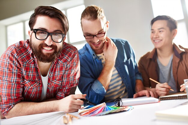 Happy teens working in their project