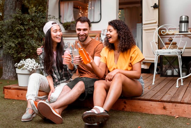 Happy three friends drinking and smiling