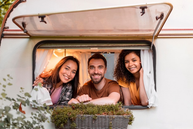 Happy three friends inside a van