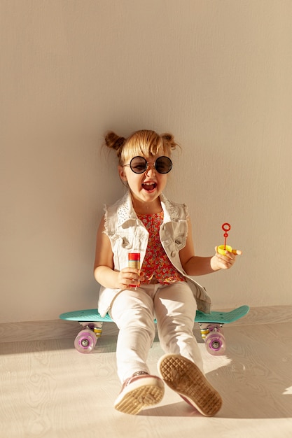 Happy toddler sitting on skateboard