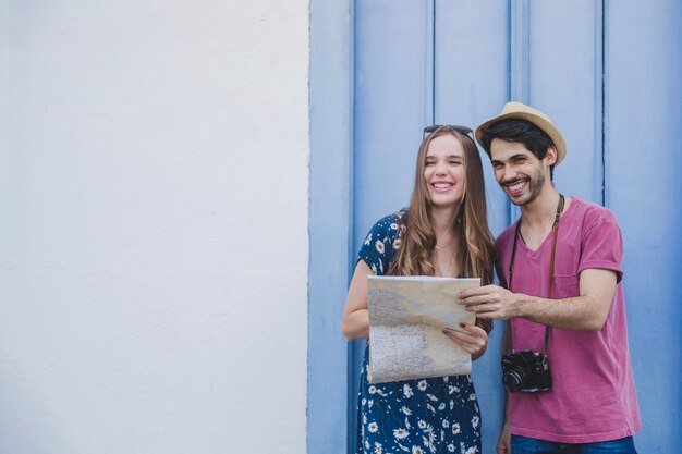 Happy tourists with map