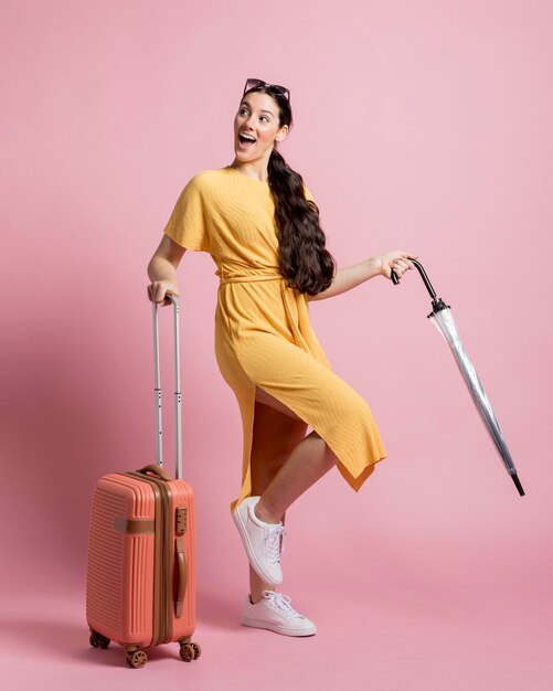 Happy traveler posing with pink background