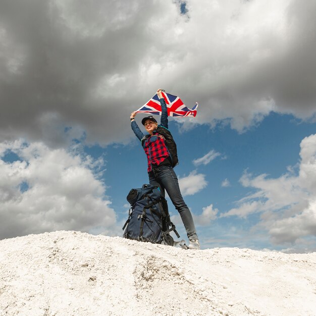 Happy traveler with a flag outdoor