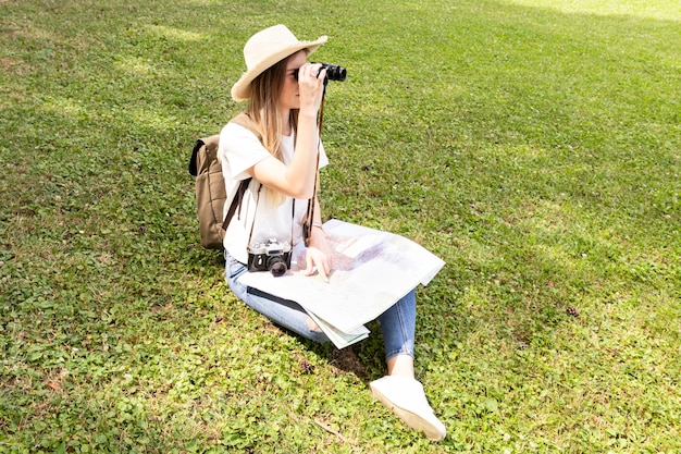 Free photo happy traveller looking through binoculars