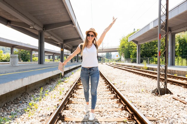 Happy traveller on railroad tracks