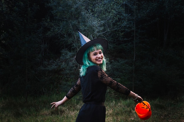 Free photo happy witch girl in woods