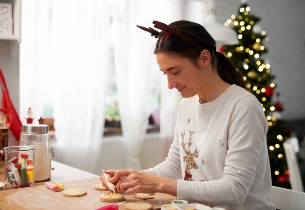 Happy woman baking cookies for Christmas