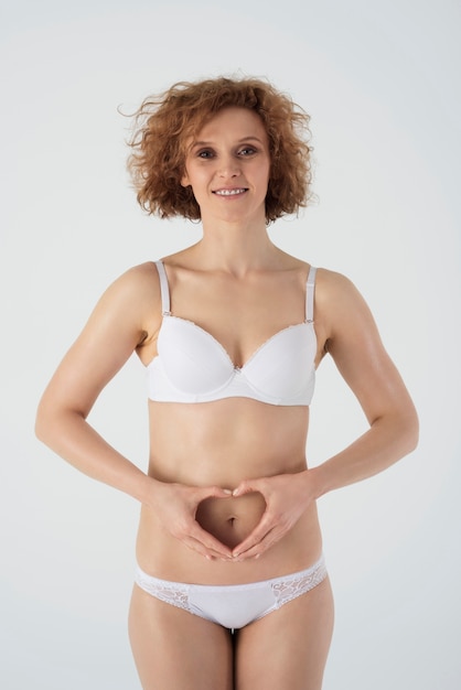 Happy woman in basic underwear isolated