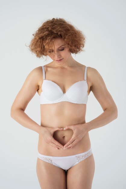 Happy woman in basic underwear isolated