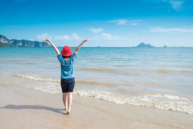 Happy Woman on the beach and clouds  sky.