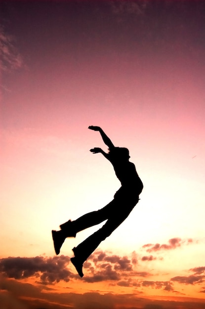 Silhouette of a child leaping.