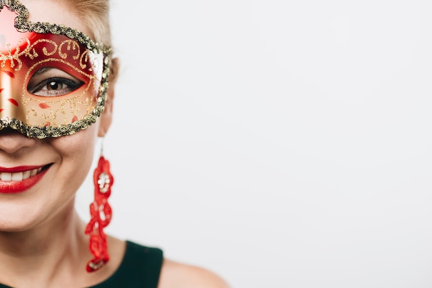 Happy woman in bright red carnival mask