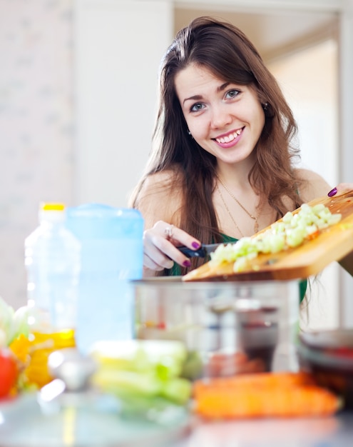 Happy  woman cooking dinner