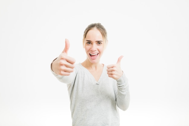 Happy woman doing thumbs up gesture