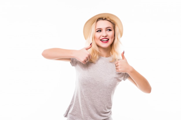 Happy woman giving thumbs up sign dressed in bright shirt