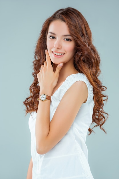 The happy woman on gray background