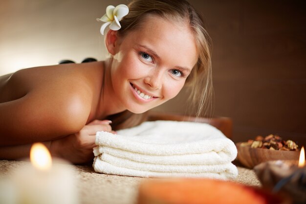 Happy woman having hot stone massage