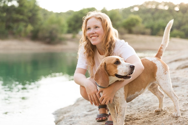 Happy woman and her best friend spending time outdoors