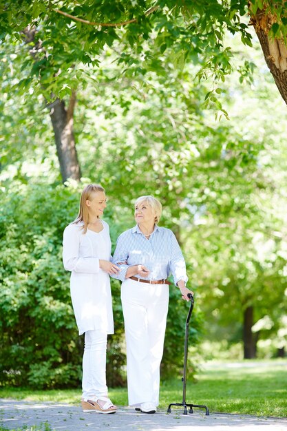 Happy woman and her helpful caregiver