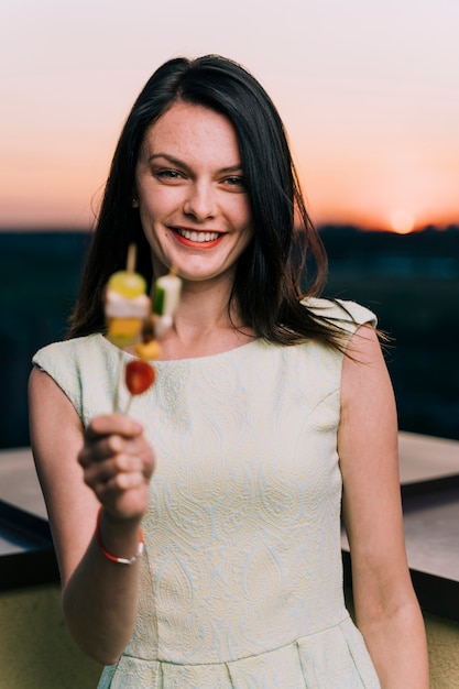 Happy woman holding appetizers medium shot