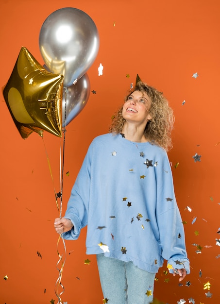 Free photo happy woman holding balloons