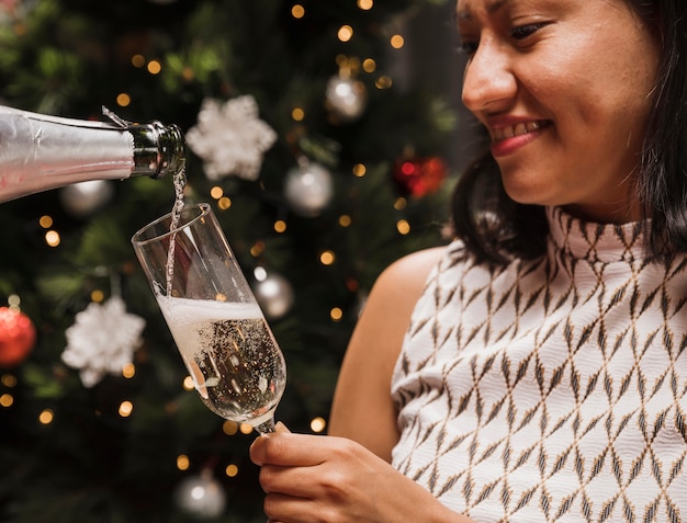 Бесплатное фото Счастливая женщина, держащая бокал с шампанским