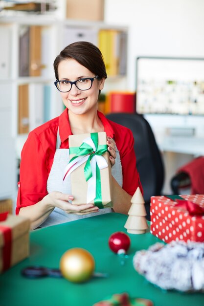 Happy woman holding a christmas gift or present