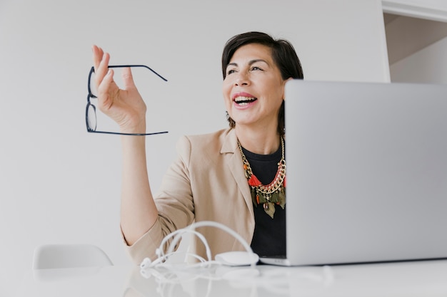 happy woman holding eyeglasses medium shot