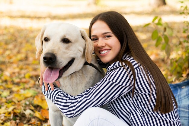 Happy woman holding her labrador