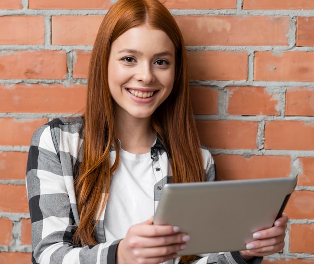 Happy woman holding ipad device