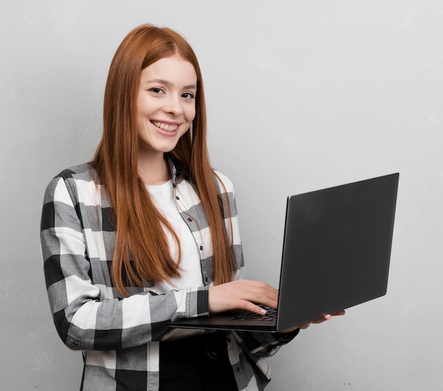 Free photo happy woman holding laptop