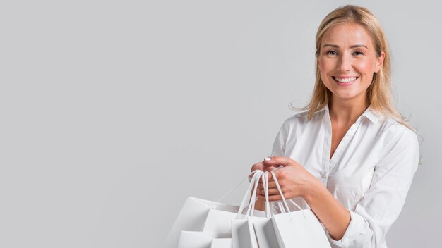 Happy woman holding lots of shopping bags