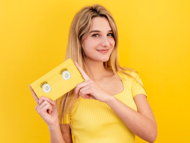 Free photo happy woman holding old tape