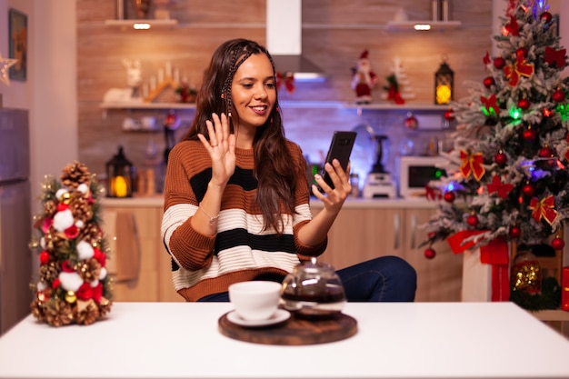 Happy woman holding smartphone for video call