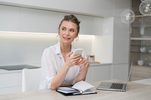 Free photo happy woman holding smartphone