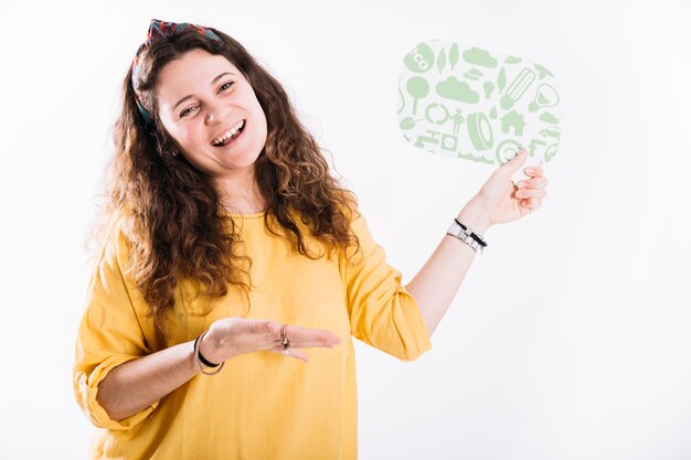 Happy woman holding speech bubble presenting against white background