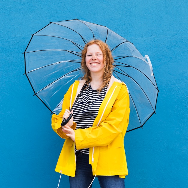 Happy woman holding umbrella