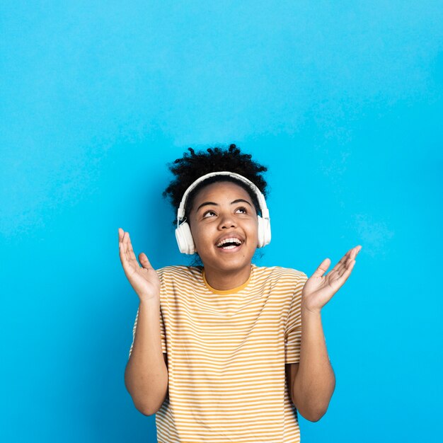 Happy woman listening to music on headphones