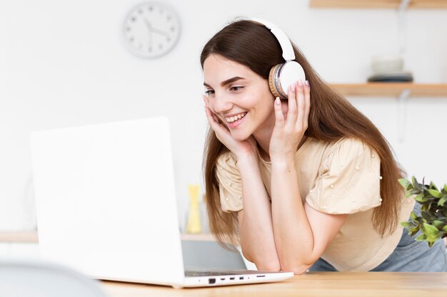 Happy woman listening to music through headphones