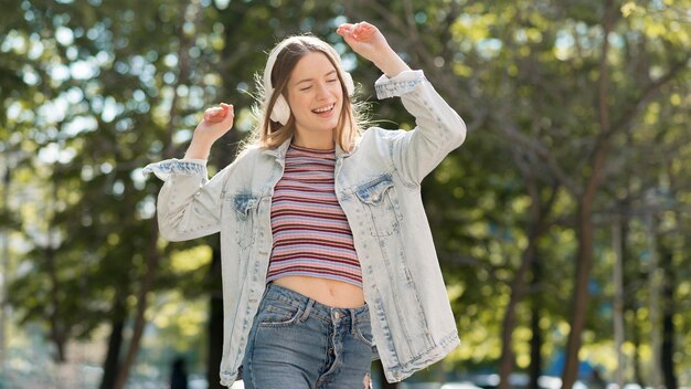 Free photo happy woman listening to music