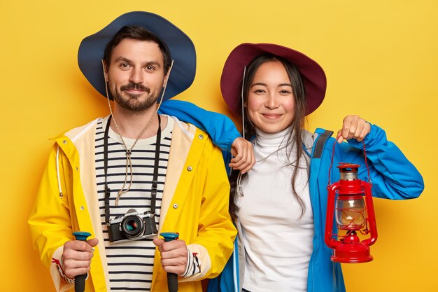 Happy woman and man tourists spend summer vacation actively, walk on foot, cover long destination